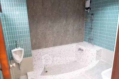 Modern bathroom with unique tiled bathtub and shower area