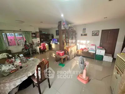 Spacious living room with natural light and eclectic decor, perfect for family gatherings.