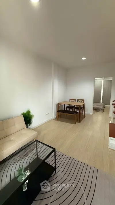 Modern living room with minimalist furniture and cozy dining area