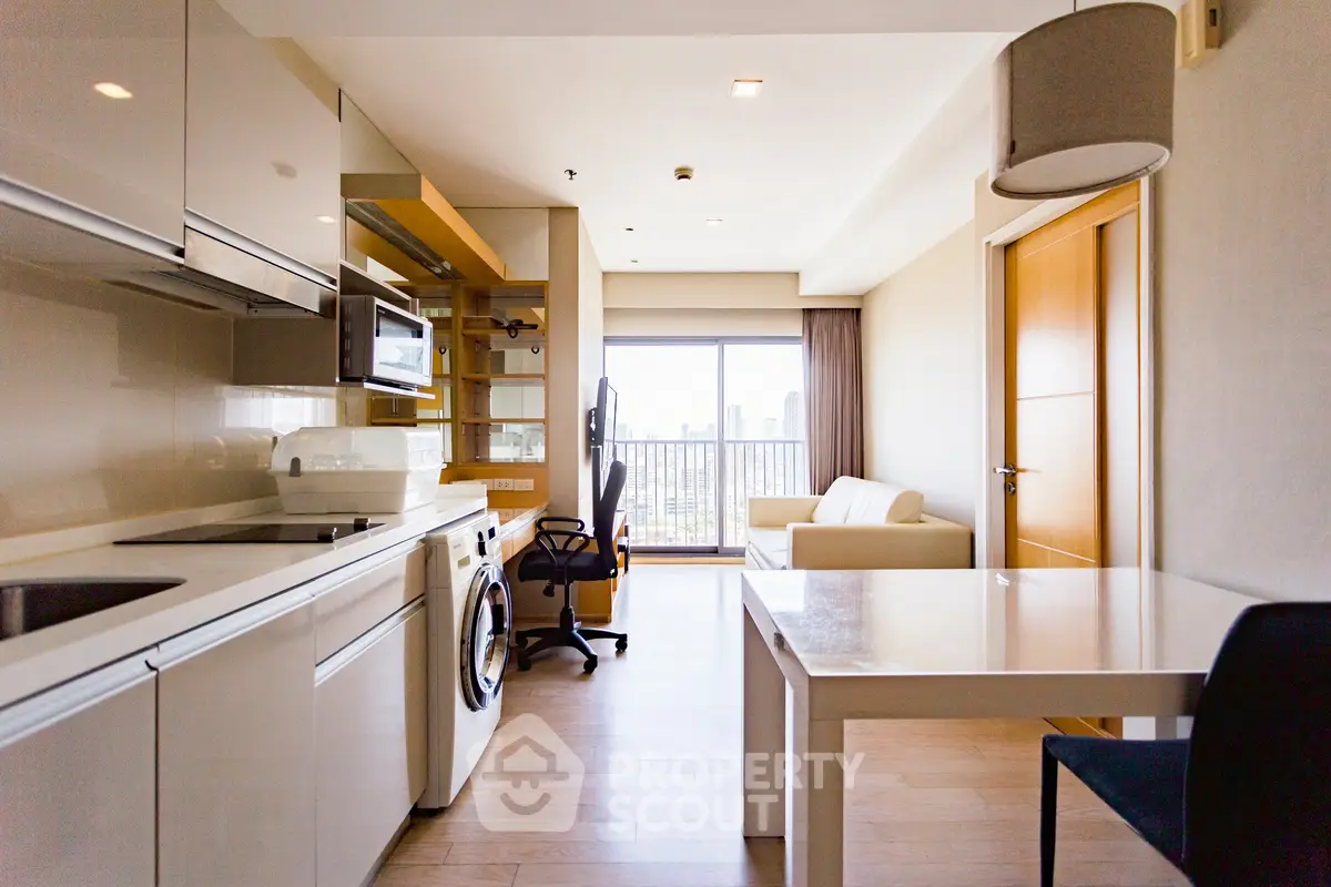 Modern open-layout apartment with kitchen, living area, and city view.