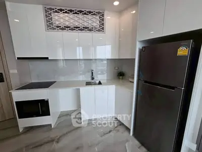 Modern kitchen with sleek white cabinets and stainless steel appliances