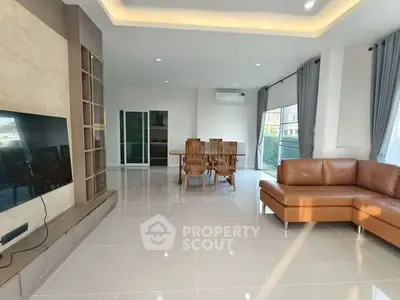 Spacious modern living room with elegant furniture and large windows for natural light.