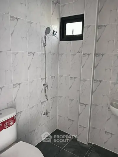 Modern bathroom with sleek marble tiles and compact design