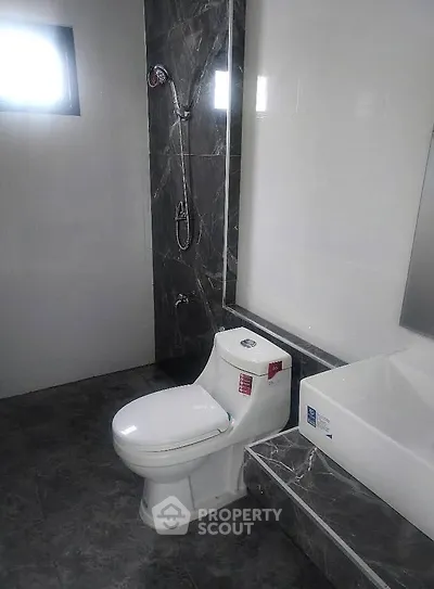 Modern bathroom with sleek fixtures and marble accents