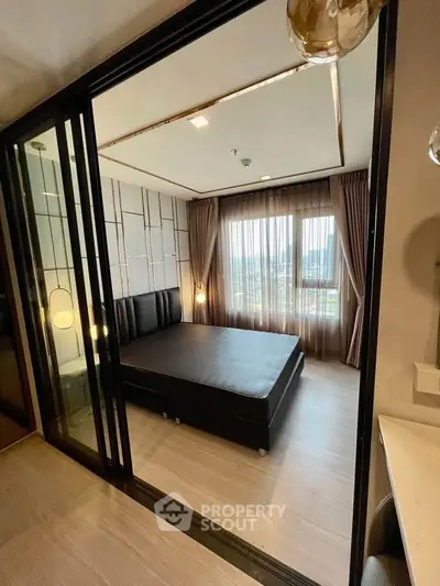 Modern bedroom with large windows and stylish decor in a high-rise apartment.