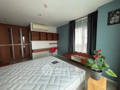 Spacious bedroom with modern decor and natural light