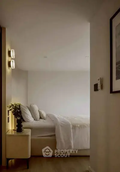 Cozy bedroom with modern decor and soft lighting, perfect for relaxation.