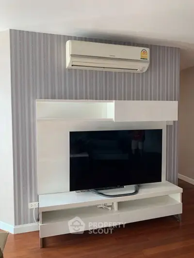 Modern living room with sleek TV unit and air conditioning