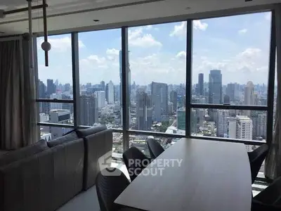 Luxurious high-rise apartment with stunning city skyline view from the living room.