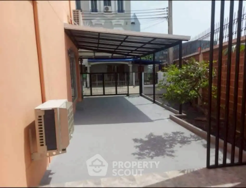 Spacious outdoor area with covered patio and garden, perfect for relaxation and entertainment.