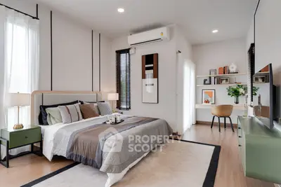 Modern bedroom with stylish decor and natural light, featuring a cozy bed and elegant furnishings.