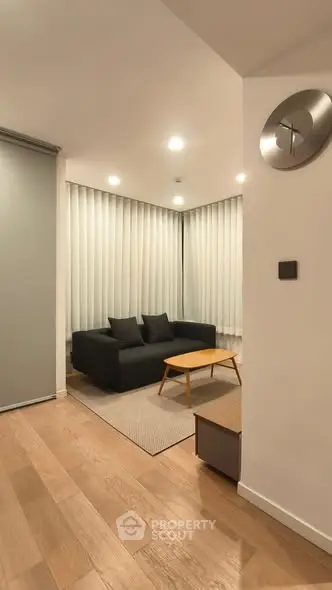 Modern living room with sleek black sofa and minimalist decor