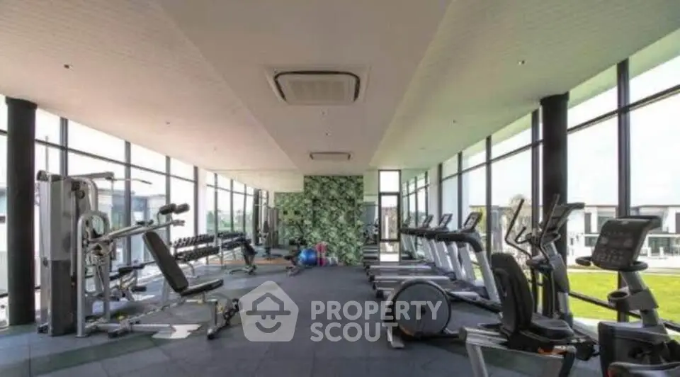Spacious modern gym with state-of-the-art equipment and panoramic windows.