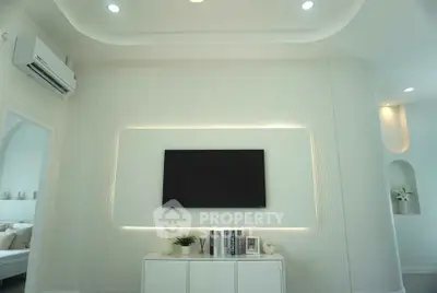 Modern living room with sleek TV setup and ambient lighting