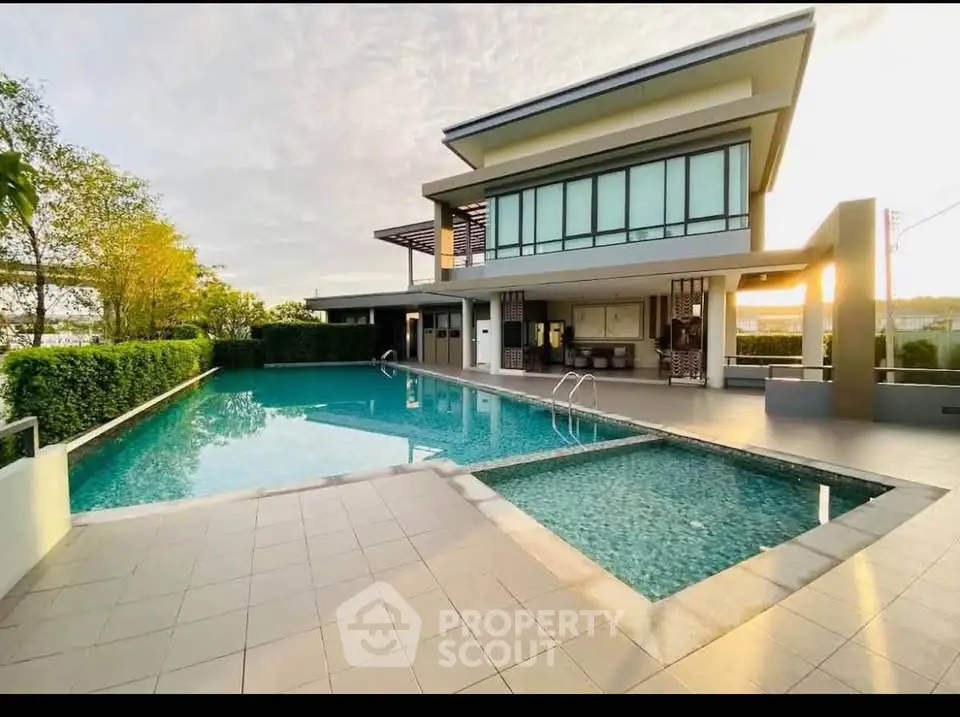 Luxurious modern building with stunning pool and sunset view