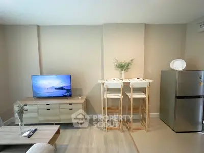 Modern living room with stylish furniture and flat-screen TV, perfect for relaxation.