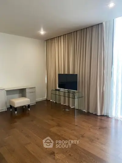 Spacious living room with hardwood floors and modern decor