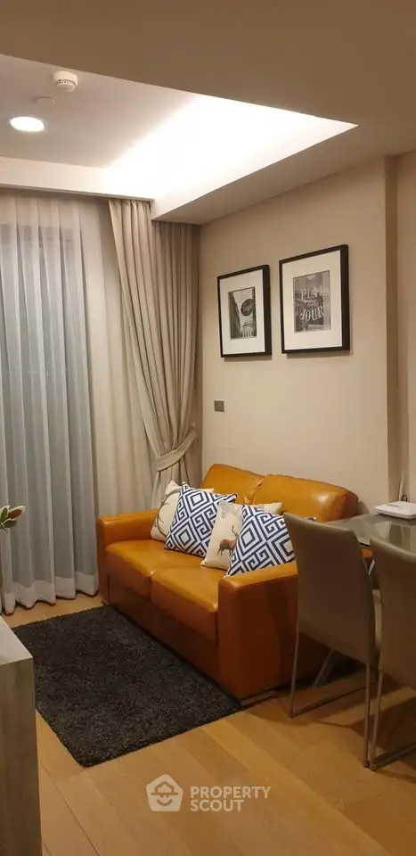 Cozy living room with leather sofa, elegant curtains, and modern decor in a stylish apartment.