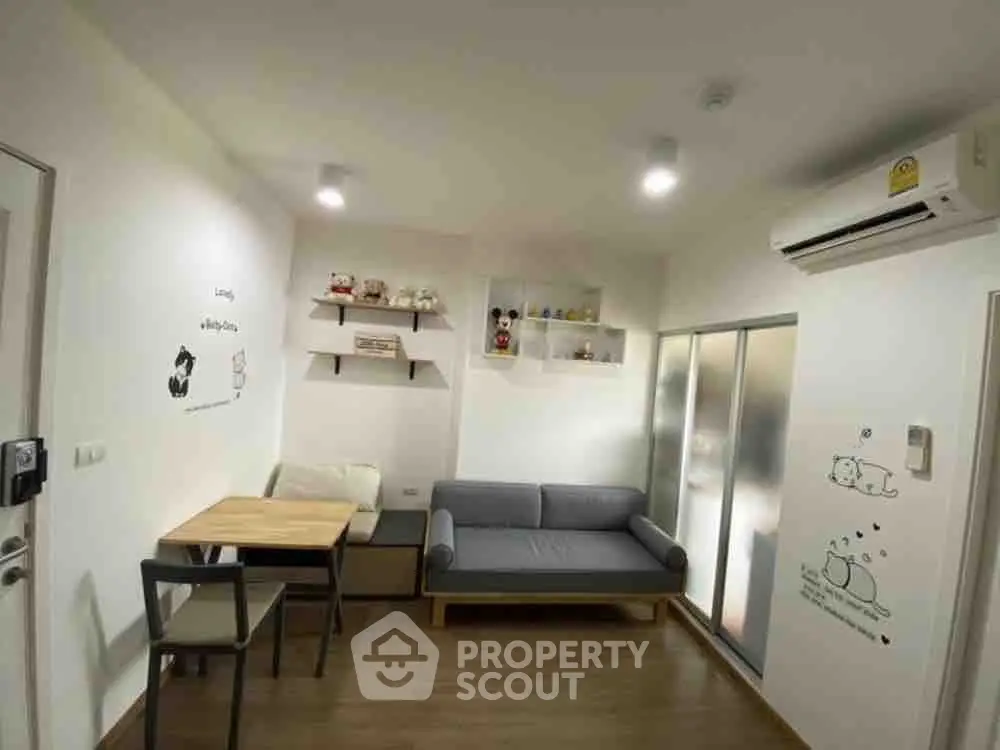 Cozy living room with modern decor and air conditioning in a stylish apartment.