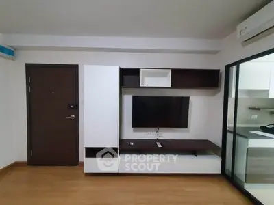 Modern living room with sleek TV unit and glass partition kitchen