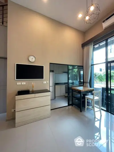 Modern living room with high ceiling and large windows