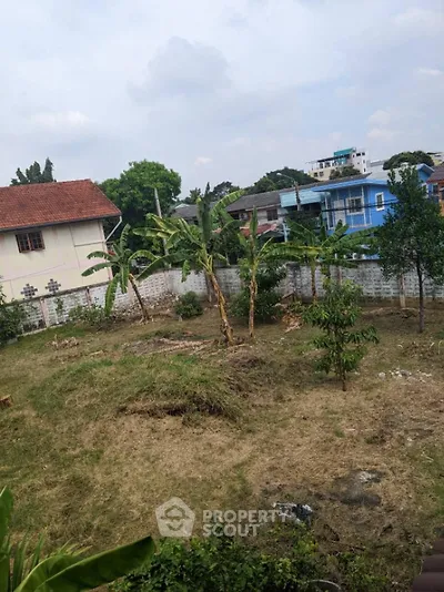 Spacious residential plot with lush greenery and potential for development in a serene neighborhood.
