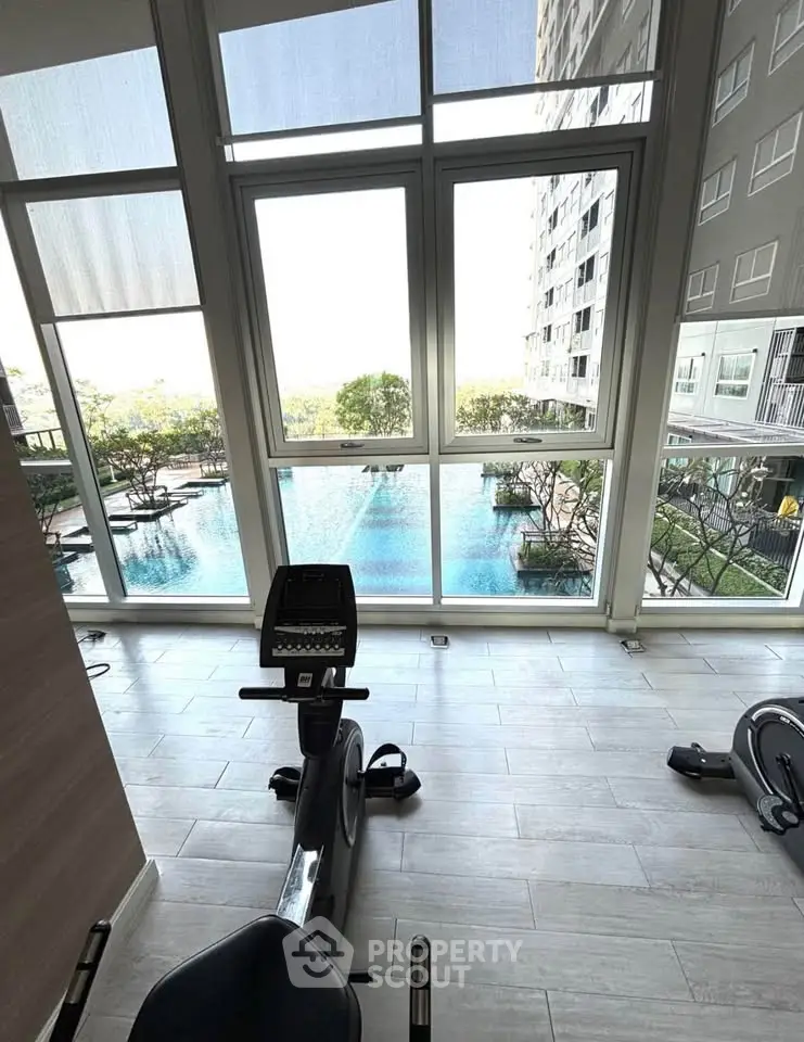 Modern gym with pool view in luxury residential building