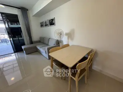 Modern living room with sleek furniture and dining area in open layout apartment
