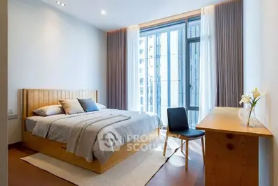 Modern bedroom with large window and stylish wooden furniture in a high-rise apartment.