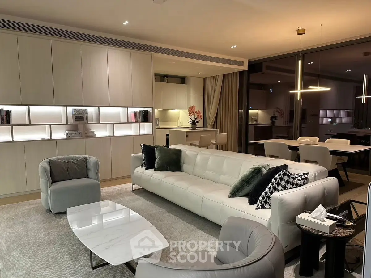 Luxurious modern living room with elegant furniture and open kitchen layout