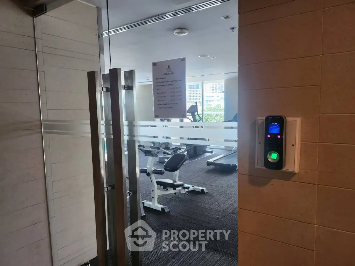 Modern gym with state-of-the-art equipment and secure access in luxury building.