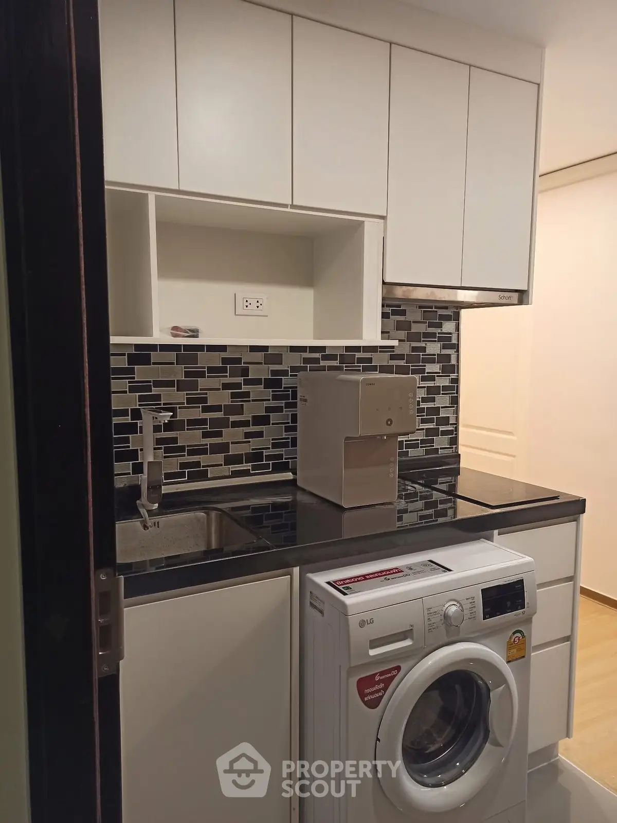 Modern kitchen with washing machine and sleek cabinetry