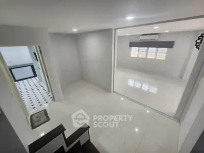 Spacious modern interior with sleek tile flooring and ample natural light, perfect for contemporary living.