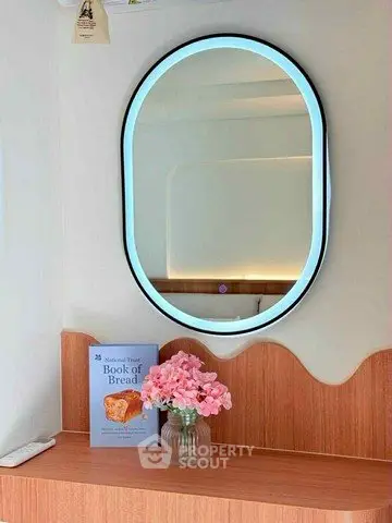 Chic interior with illuminated mirror and stylish decor, perfect for modern living spaces.