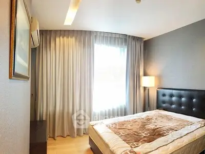 Cozy bedroom with modern decor and ample natural light