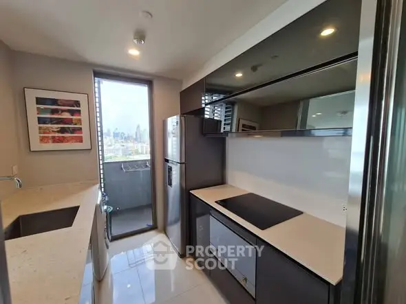 Modern kitchen with sleek design and city view from balcony