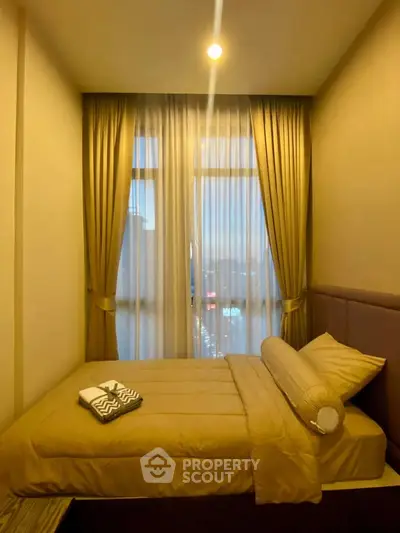 Cozy bedroom with elegant curtains and ambient lighting, perfect for relaxation and comfort.