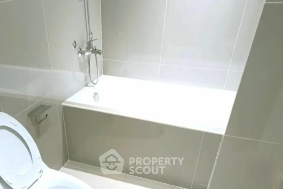 Modern bathroom with sleek bathtub and tiled walls