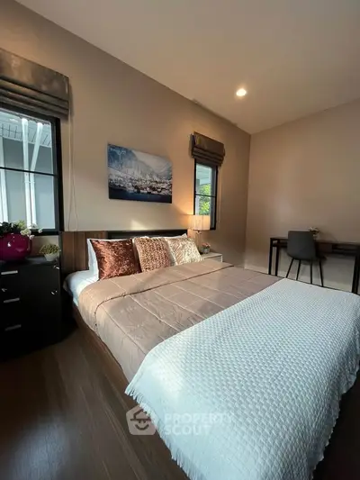 Modern bedroom with stylish decor and cozy ambiance, featuring a comfortable bed and elegant furnishings.