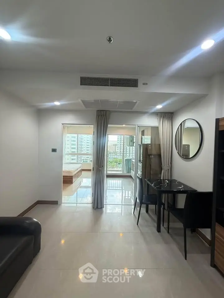 Modern living room with open layout and balcony view in urban apartment