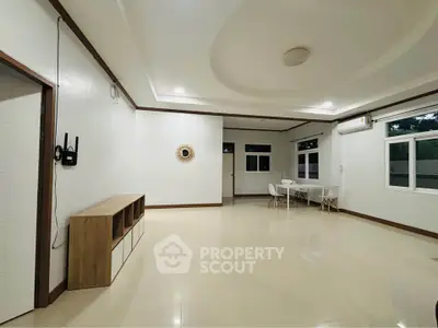 Spacious modern living room with elegant ceiling design and natural light.