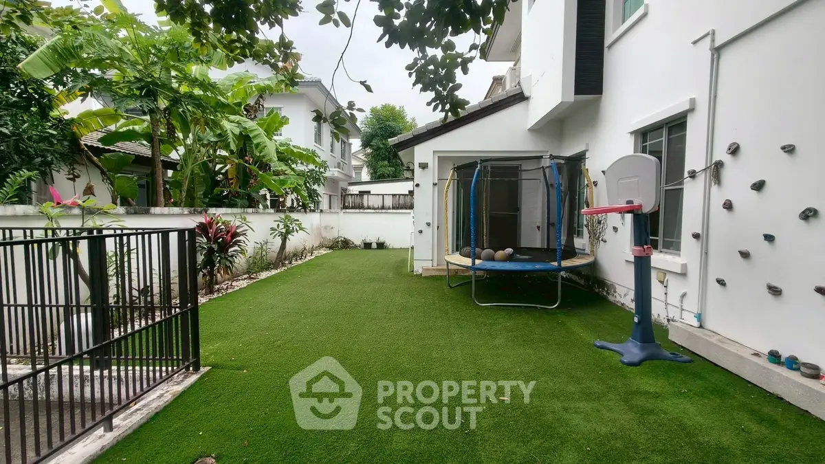 Spacious backyard with trampoline and climbing wall in modern home