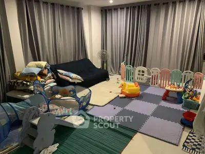 Spacious living room with play area and cozy seating