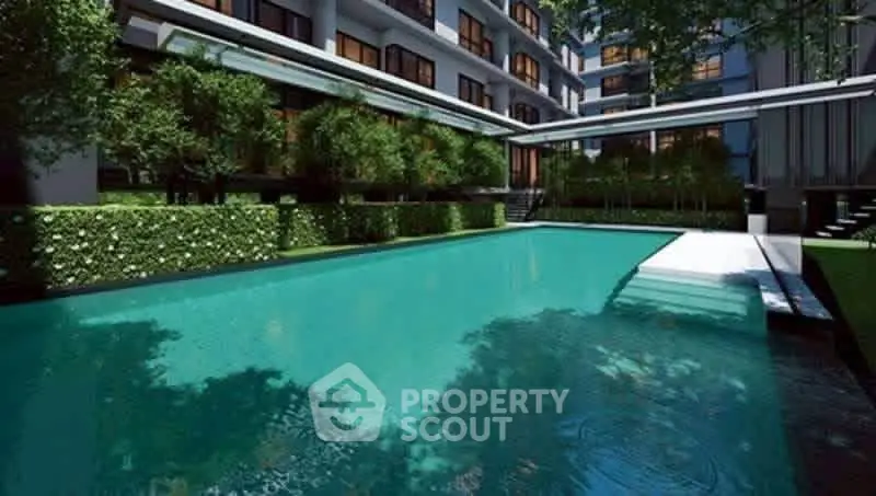 Luxurious apartment complex with stunning outdoor pool and lush greenery.