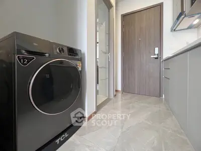 Modern kitchen with sleek appliances and stylish flooring in a contemporary apartment.