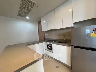 Modern kitchen with sleek white cabinets and stainless steel appliances