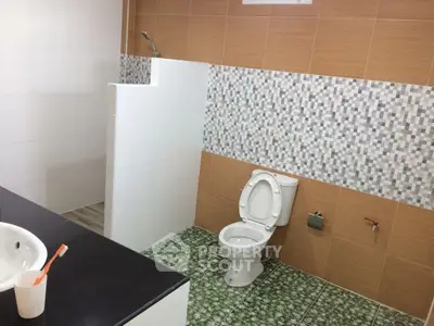 Modern bathroom with stylish tile design and open shower area