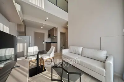 Modern living room with sleek furniture and open kitchen in a stylish apartment
