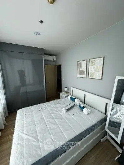 Modern bedroom with sleek design, featuring a large bed, stylish decor, and ample natural light.
