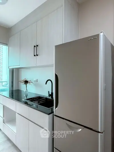 Modern kitchen with sleek cabinetry and stainless steel fridge